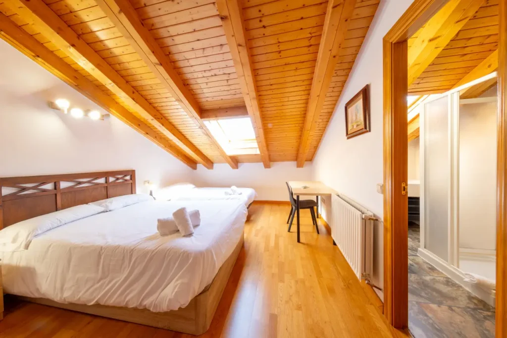 Dormitorio con cama de matrimonio y escritorio